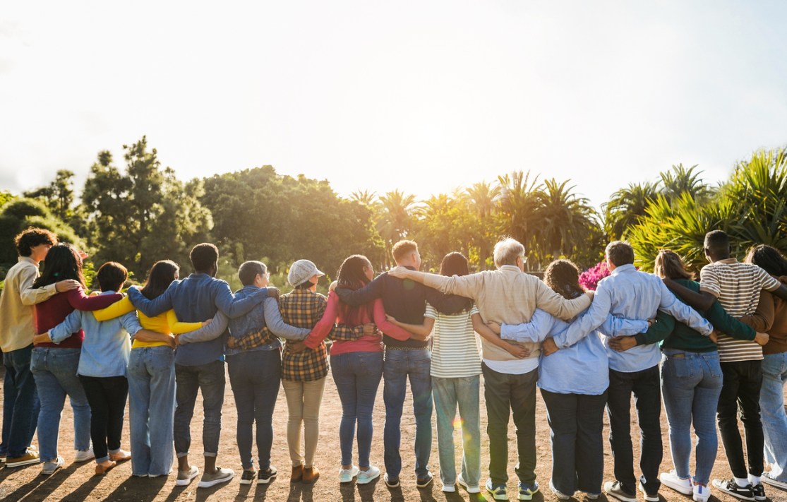 A large group of people embracing in a line.