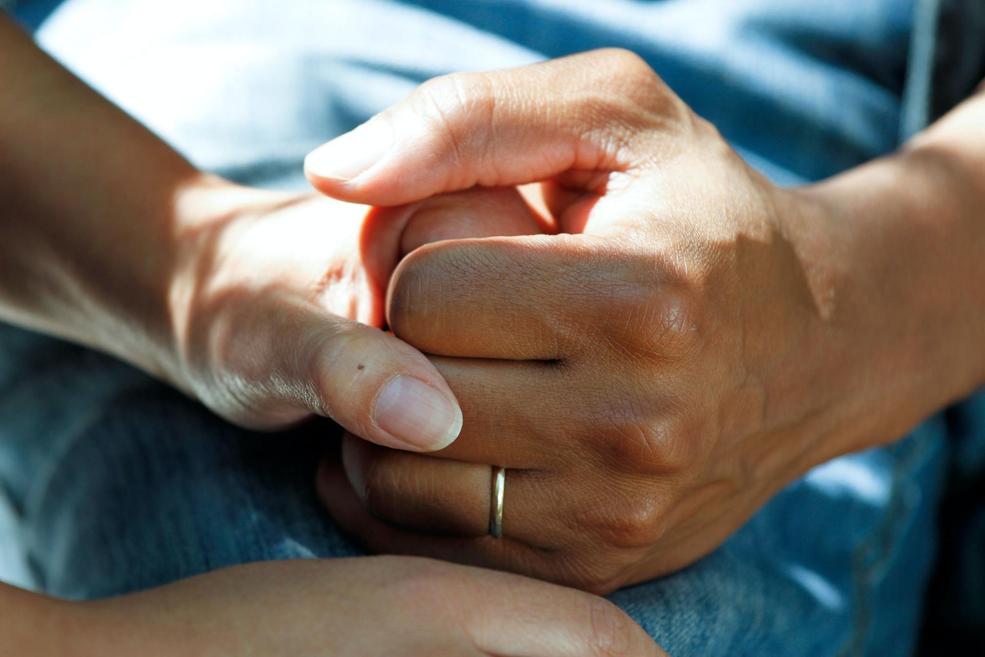 A person holding a cancer patient's hand