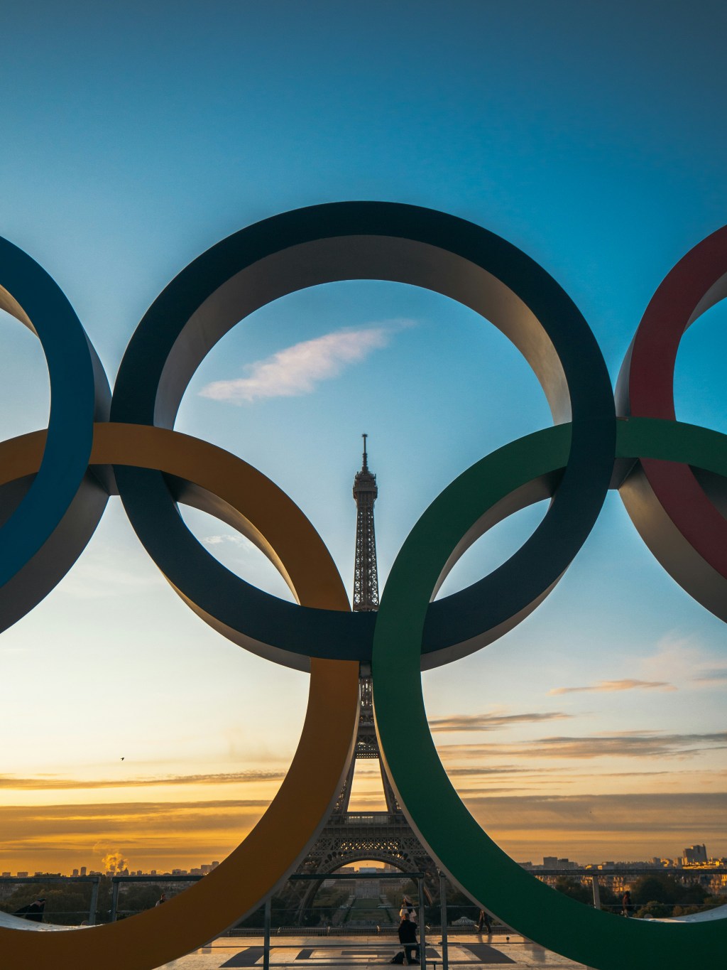 Olympic rings with the Eiffel Tower in the distance